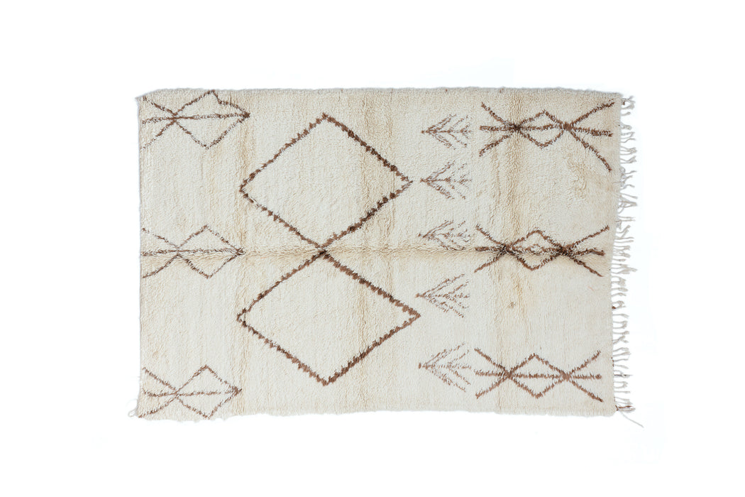 A soft and authentic Beni Ourain rug hand woven by the Beni Ourain tribes of Morocco featuring Amazigh geometric designs on natural cream wool. Large statement Rug