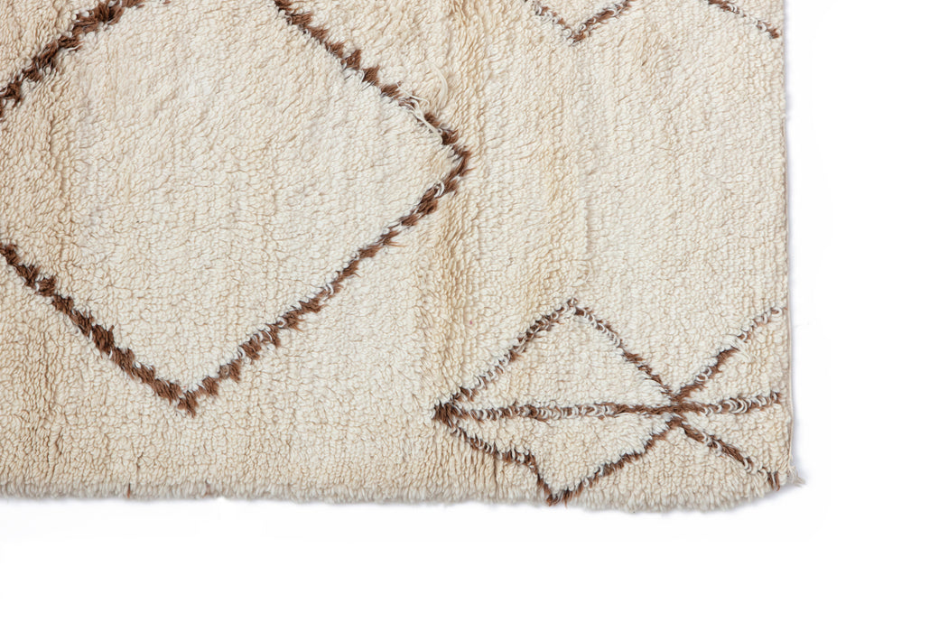 A soft and authentic Beni Ourain rug hand woven by the Beni Ourain tribes of Morocco featuring Amazigh geometric designs on natural cream wool. Large statement Rug